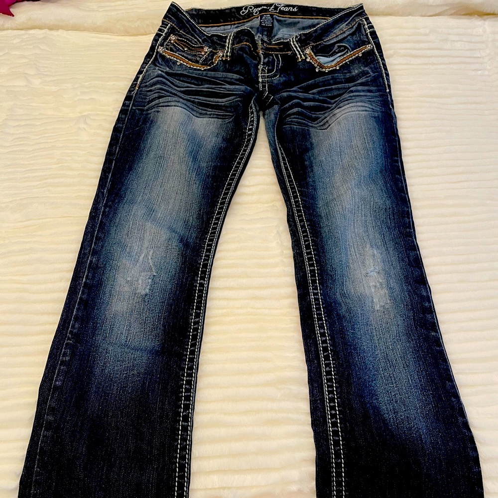 Dark jeans with fade wash and embellishments